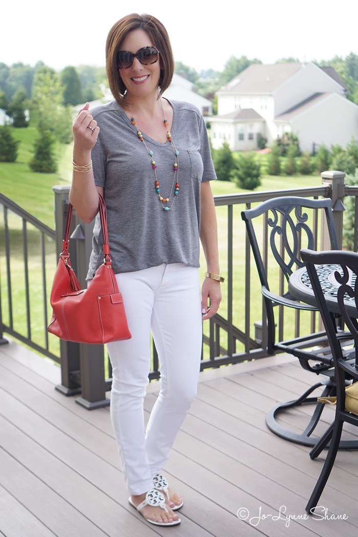 Simple Summer Chic: Grey Tee + White Jeans. The coral bag lends a fun contrast.