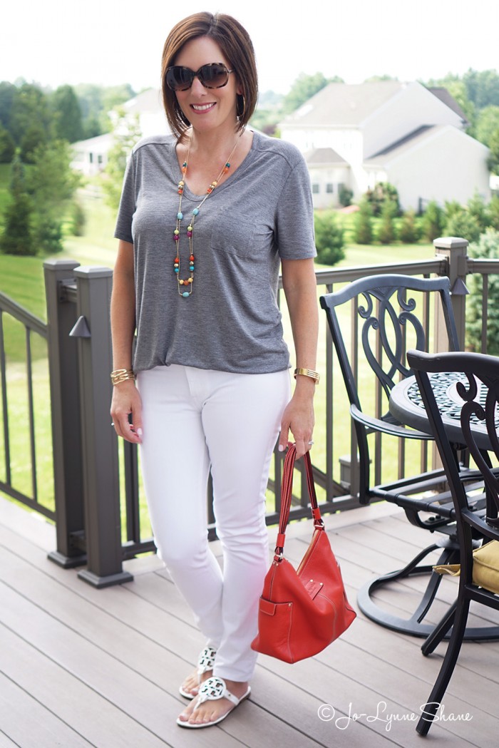 Simple Summer Chic: Grey Tee + White Jeans. The coral bag lends a fun contrast.