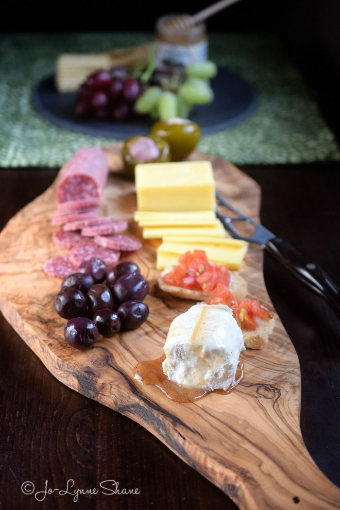 A beautiful Antipasto presented on an artisan olive cutting board makes a gorgeous rustic dish for casual entertaining! 