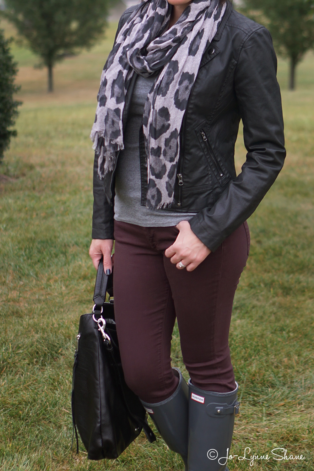 Fall Fashion for Women Over 40: Rain boots with plum skinny jeans, grey animal print scarf and moto jacket