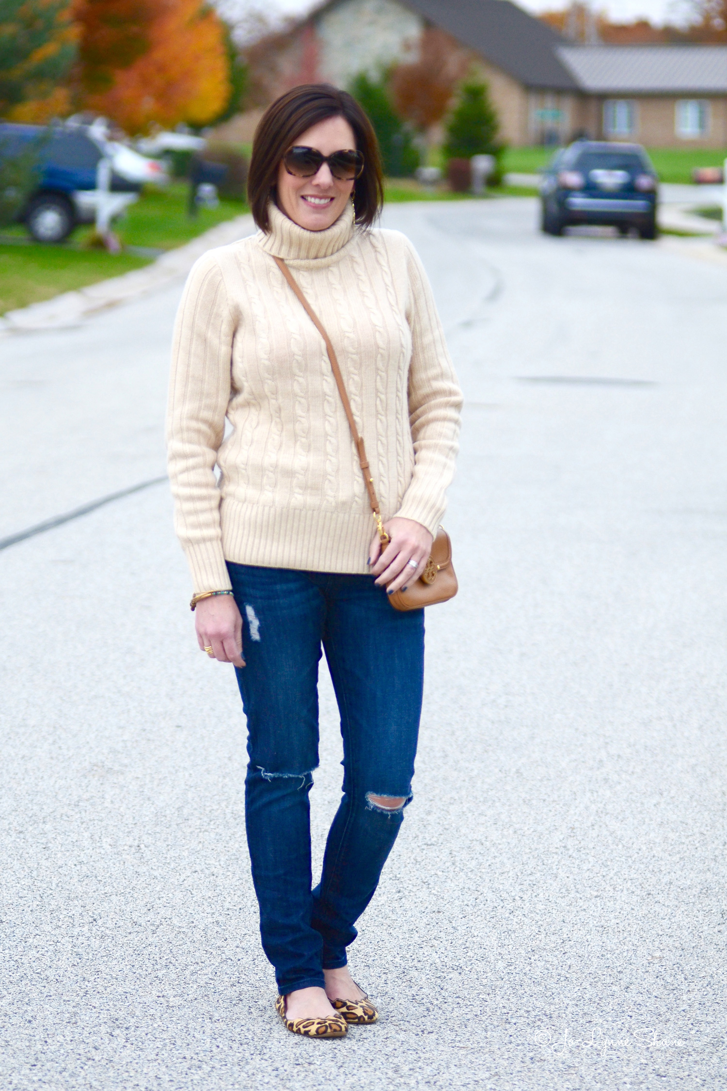 Fall Fashion for Women Over 40: Cambridge Cable Chunky Turtleneck with Destructed Jeans and Leopard Flats