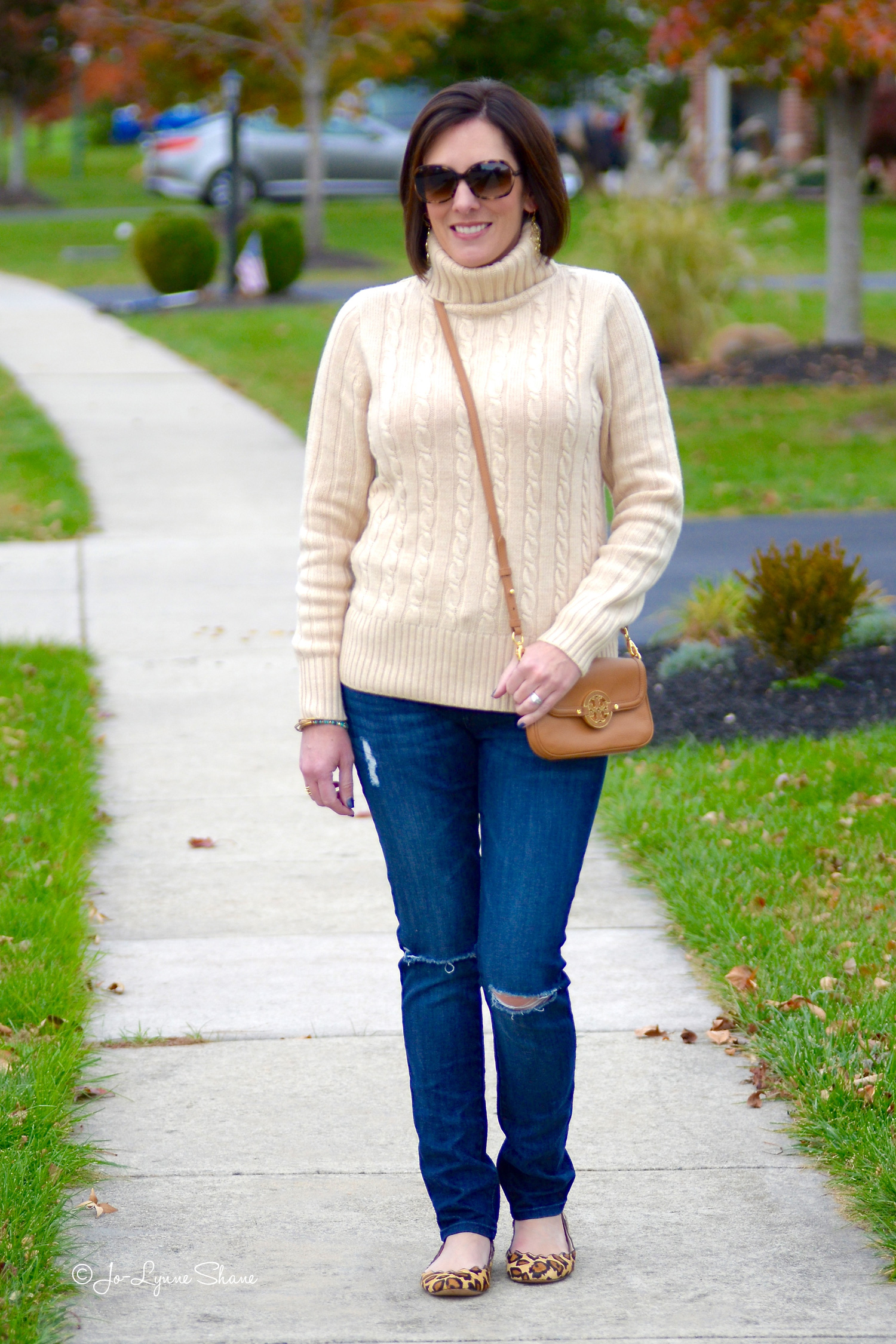 Fall Fashion for Women Over 40: Cambridge Cable Chunky Turtleneck with Destructed Jeans and Leopard Flats