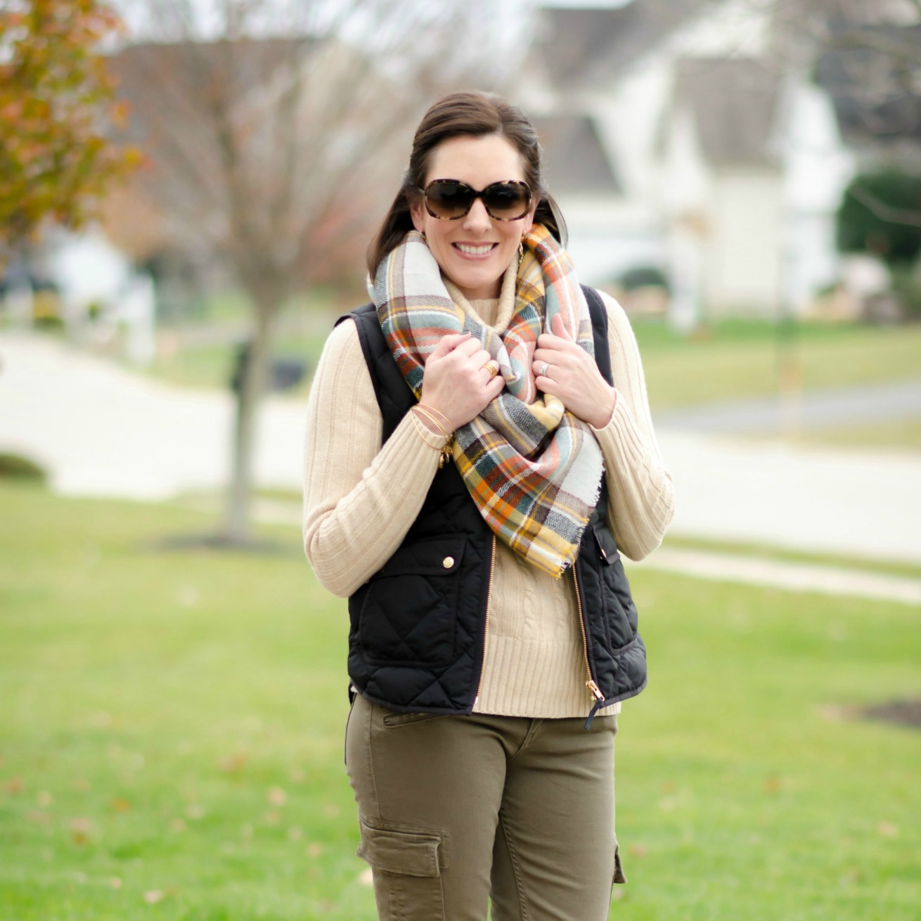 Casual Winter Outfit: plaid oversized scarf with down vest, chunky turtleneck, cargo skinnies and riding boots