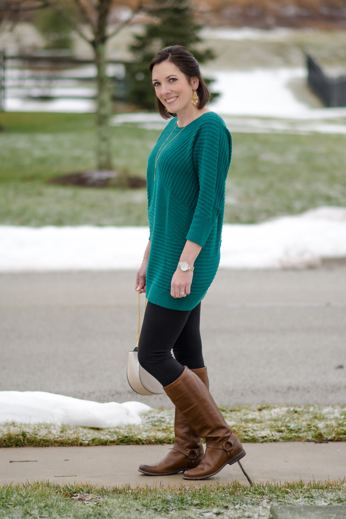 Spring Fashion for Women Over 40: green tunic, black leggings, brown Frye riding boots