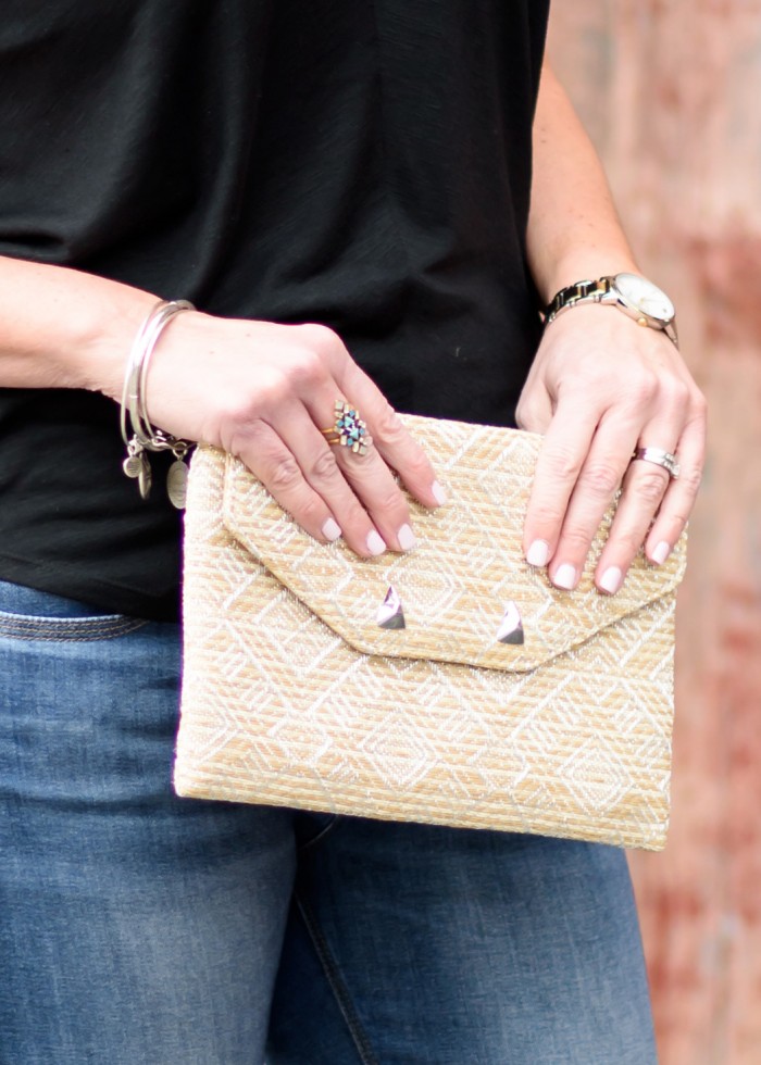 Accessorize for Spring with a statement ring and straw clutch
