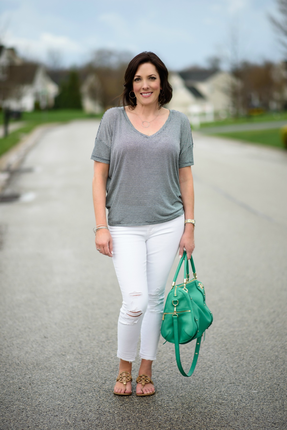 Casual Spring Outfits for Women Over 40: Navy and White Stripe Dolman Sleeve Top with White Jeans and Nude Sandals