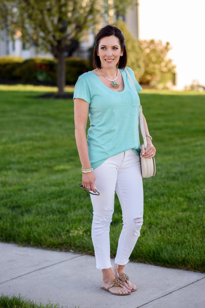 Jo-Lynne Shane wearing teal t-shirt with white distressed jeans and nude sandals