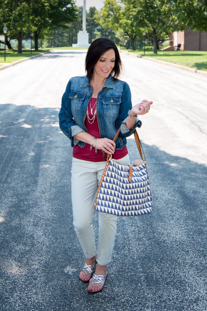 denim jacket with red tank and stripe crop pants