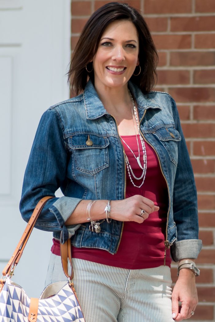 jean jacket with red tank over striped pants top