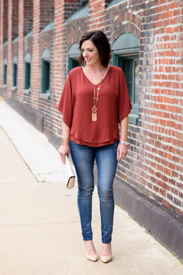 How to Dress Up Casual Jeans: Jo-Lynne Shane wearing rust Kimono Blouse from White House Black Market with blue jeans and nude pumps. The C. Wonder Tassel Necklace c/o QVC is the perfect pop of bling to complete the look.