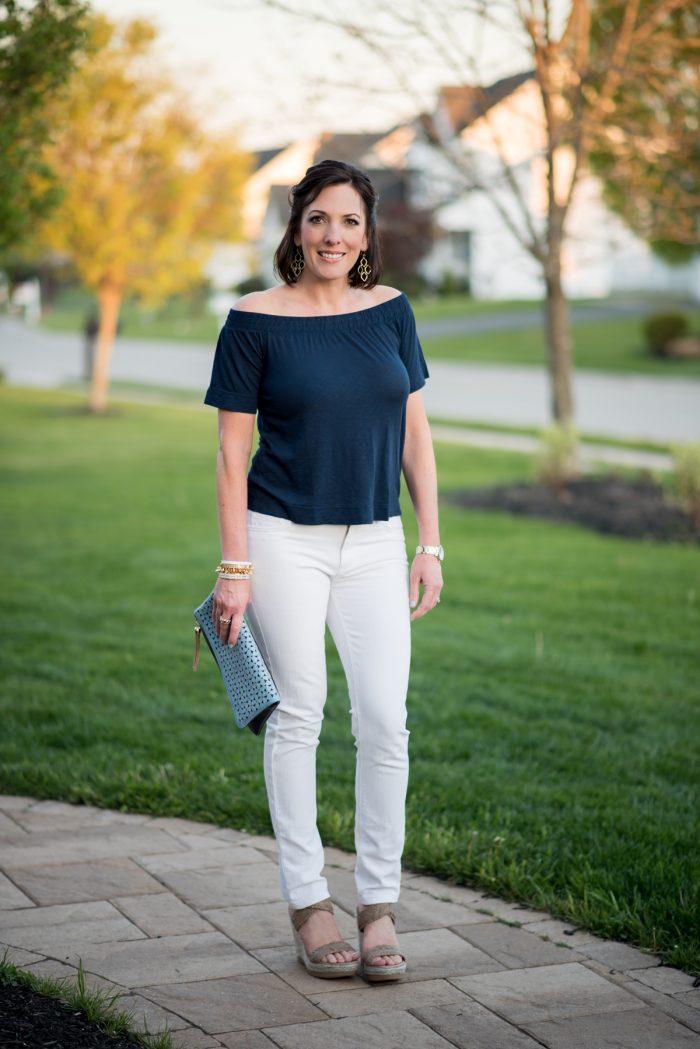 Jo-Lynne Shane wearing an off the shoulder top with white jeans and wedge sandals. I love this fresh, flirty spring outfit.