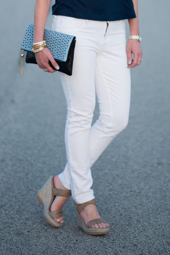 Jo-Lynne Shane wearing an off the shoulder top with white jeans and wedge sandals. I love this fresh, flirty spring outfit.