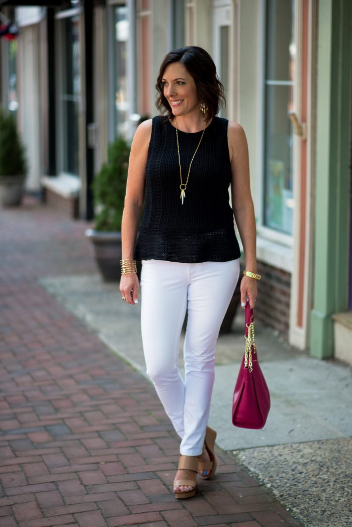 Summer Fashion Over 40: This black crochet peplum sweater with white jeans is a classic summer outfit that can take you from the office to dinner. 