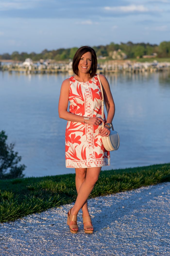 This bright coral and white floral sleeveless shift dress with crochet lace detail is a summer classic. Dress it up with wedge sandals or down with flats.