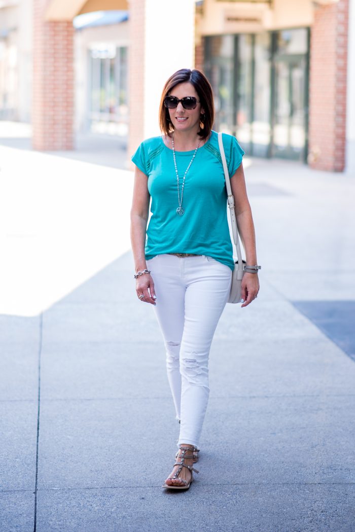 The perfect mom about town outfit -- chic but comfortable. Teal tee, white jeans, and studded gladiator sandals. 