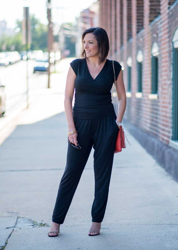 How to Wear a Jumpsuit: An all black jumpsuit is stunning with leopard sandals and an orange clutch! 