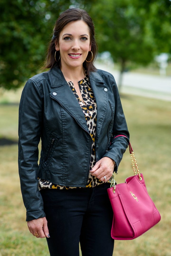 Leopard silk blouse with a moto jacket, black jeans, and a pop of pink!