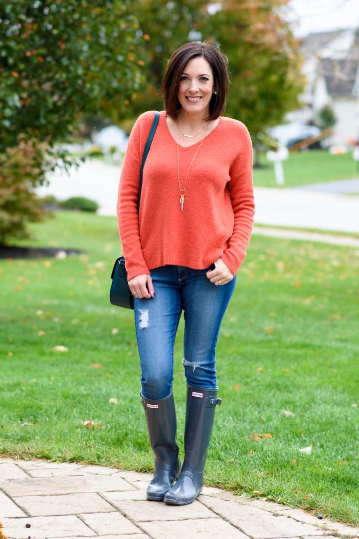 Fashion over 40: This cozy v-neck sweater, distressed jeans, and hunter boots makes the perfect fall rainy day outfit for running around town.
