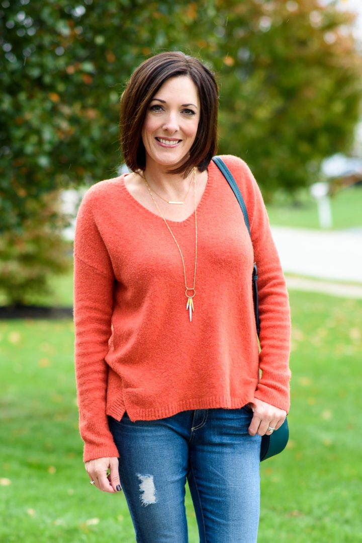 This cozy v-neck sweater, distressed jeans, and hunter boots makes the perfect fall rainy day outfit for running around town.