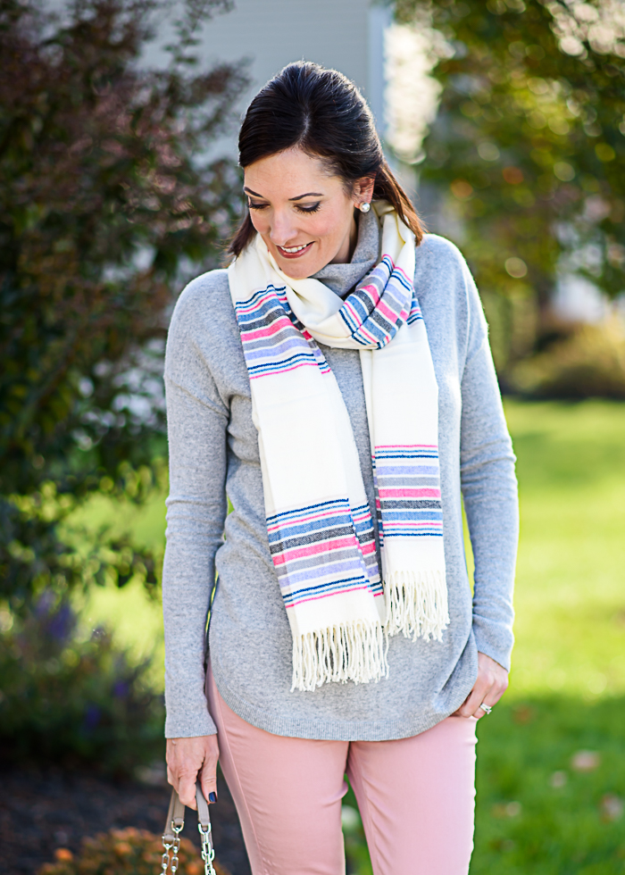 How to Wear Pastels for Fall: Styling this grey turtleneck sweater with pale pink jeans and and a cozy striped scarf.