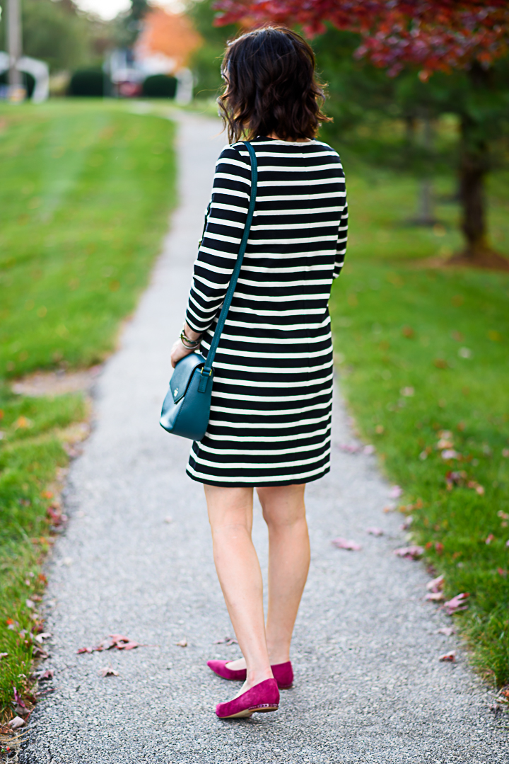 How to Wear a Black and White Striped Dress for Fall: with pink suede flats and teal crossbody bag