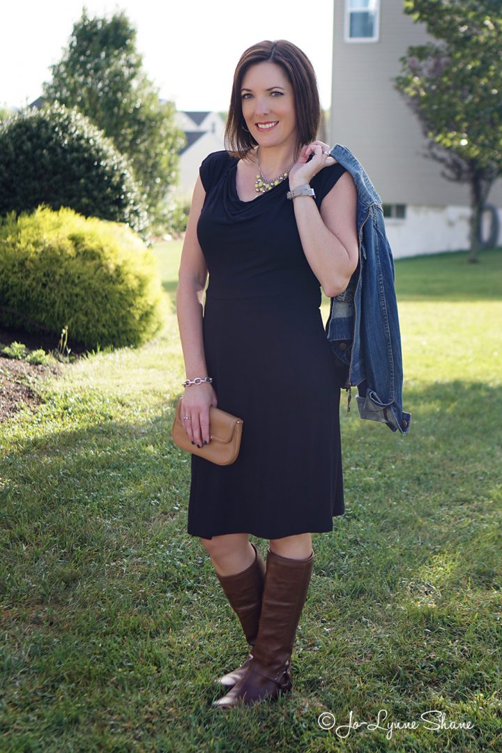 How to Wear Brown Boots with Black Based Outfits: Brown Riding Boots with a Black Jersey Knit Dress and a Jean Jacket. Carry a cognac colored bag.