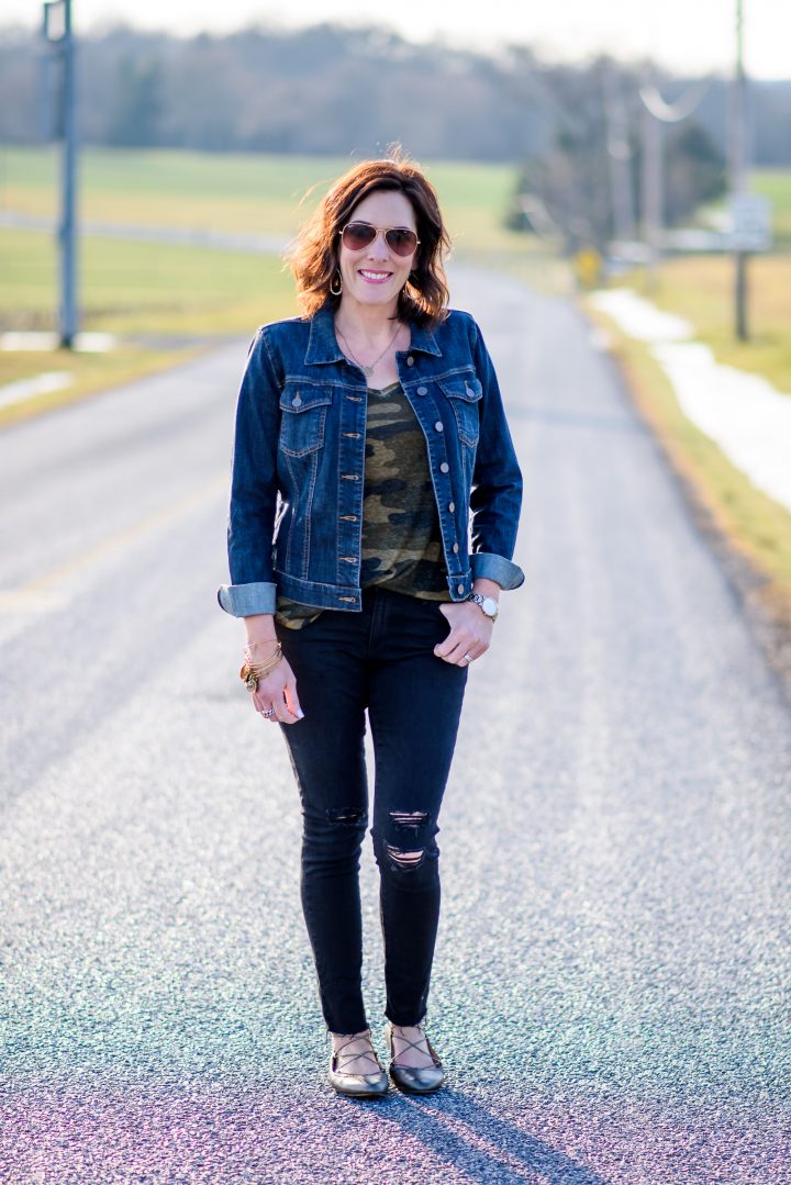 Today I'm styling a camo tee outfit for spring with black distressed skinny ankle jeans, a denim jacket, and pewter lace-up flats.