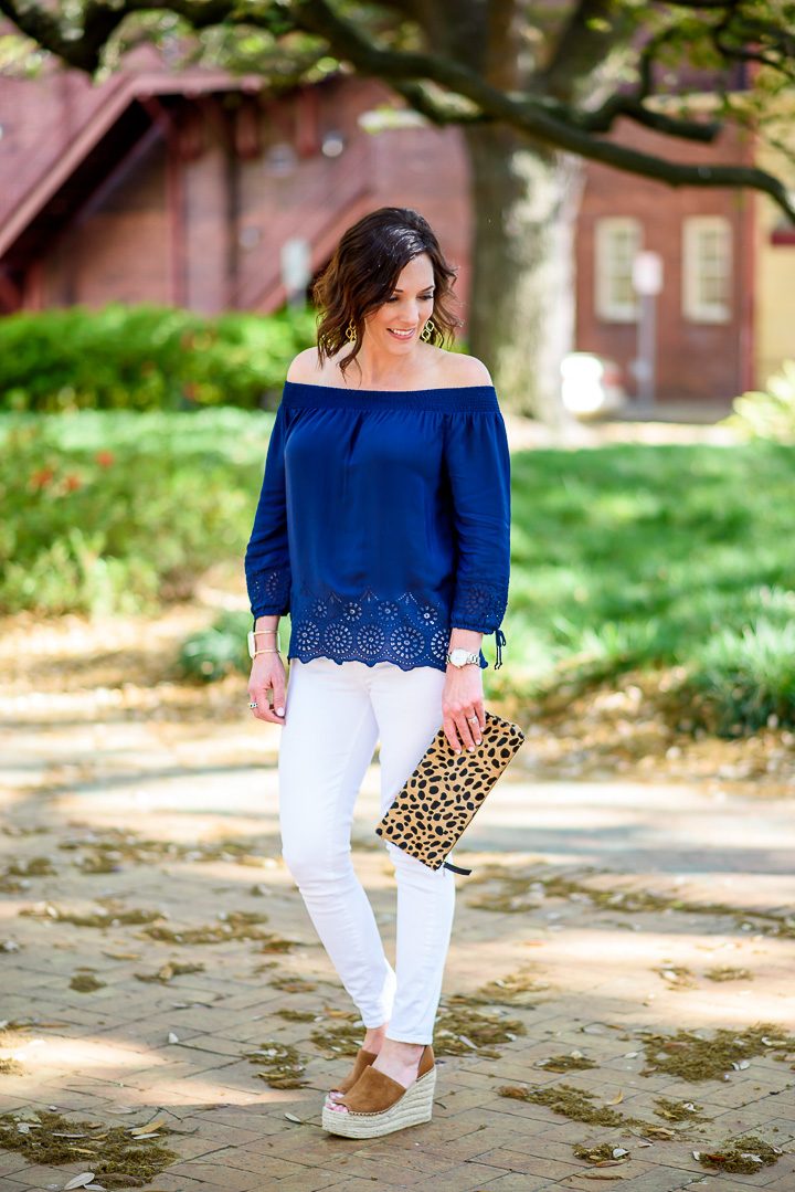 I'm styling a navy eyelet off-the-shoulder top with white jeans and chestnut espadrille wedges. The leopard clutch and chandelier earrings make it perfect for date night!