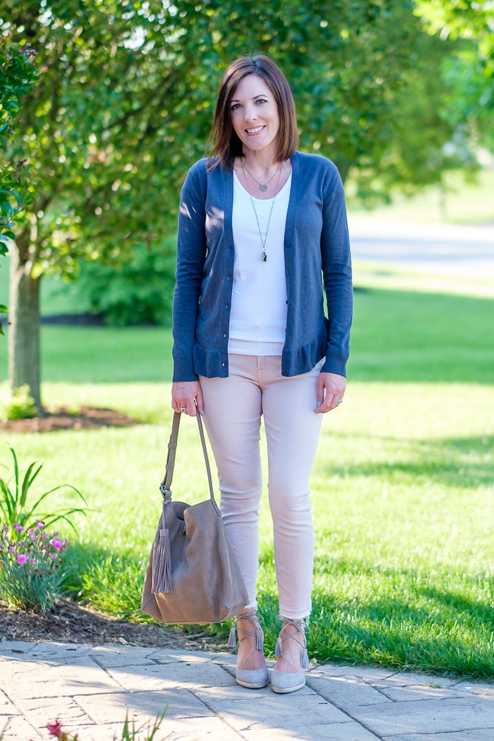 Summer work wear outfit featuring a ruffle hem cardigan, pink pants, and white v-neck tapered tee c/o Tapered Collection. 