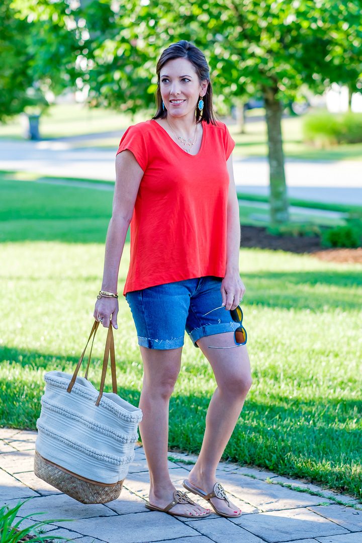 A casual summer swing top and denim shorts outfit featuring Loft vintage soft swing tee in red tamale with 6-inch denim roll shorts and Tory Burch Miller Sandals.