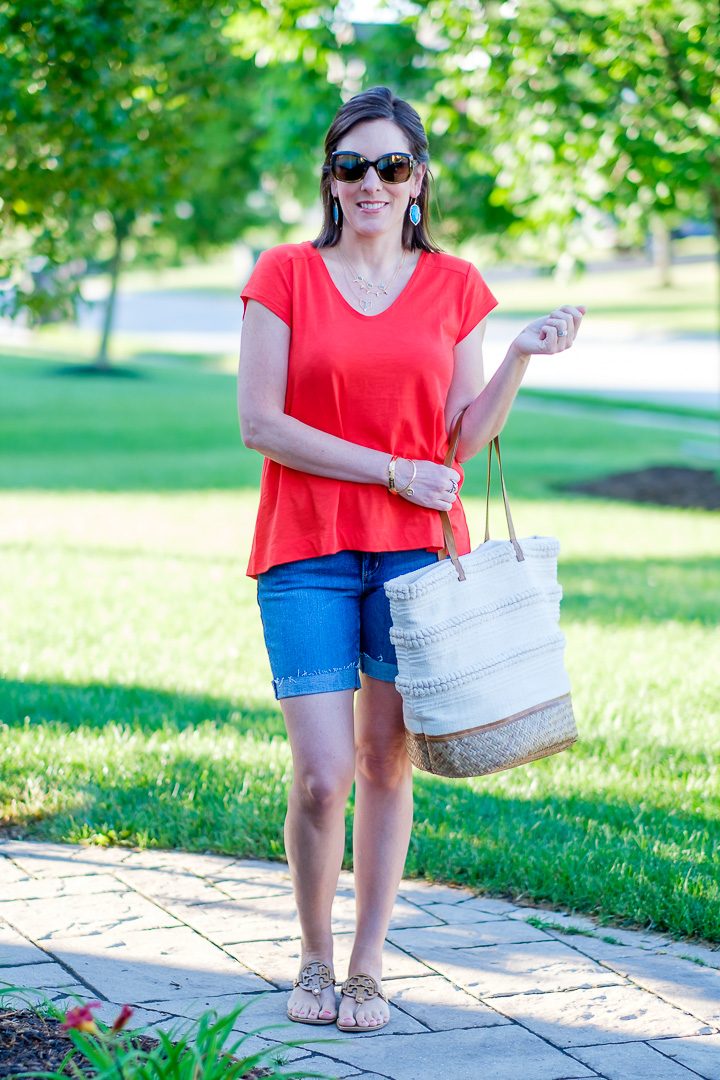 A casual summer swing top and denim shorts outfit featuring Loft vintage soft swing tee in red tamale with 6-inch denim roll shorts and Tory Burch Miller Sandals.