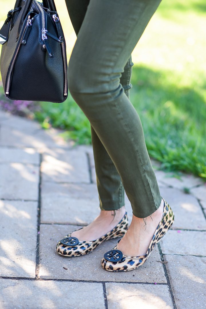 How to Wear Spruce Green Jeans: I topped my spruce green skinnies with a white cami and cognac moto jacket and finished the look with leopard flats and a black satchel.