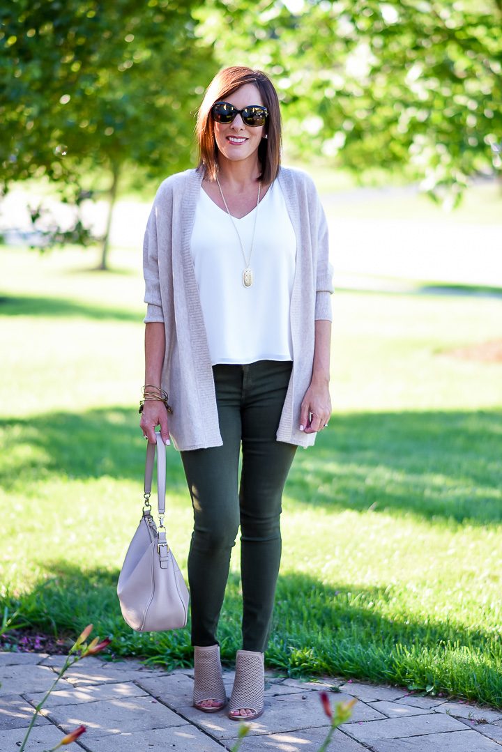 How to Wear Spruce Green Jeans: I topped my spruce green skinny jeans with a white cami and blush cardigan, and I added a pair of perforated peep toe booties in a coordinating shade of blush. Blush and spruce are a great combination, and I like how this combination lightens up the dark green jeans.